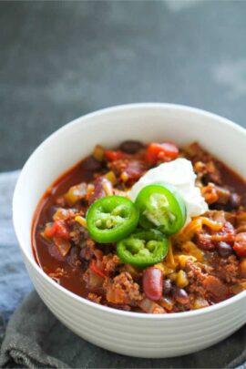 A bowl of The Best Homemade Chili Recipe with sour cream and jalapenos