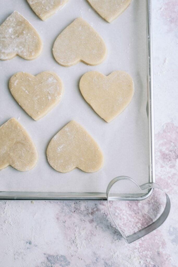 Sugar Cookie Dough Hearts on a baking sheet lined with parchment paper.