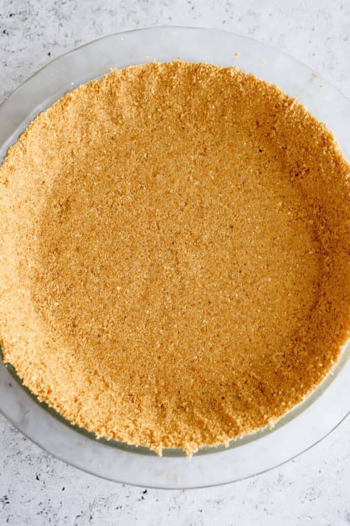 Graham cracker crust pressed into a pie plate.