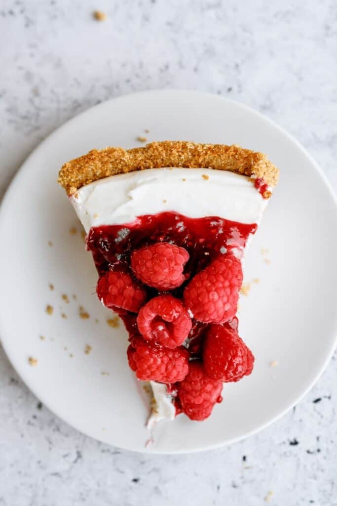 Top view of a slice of Raspberry Cream Cheese Pie on a plate.