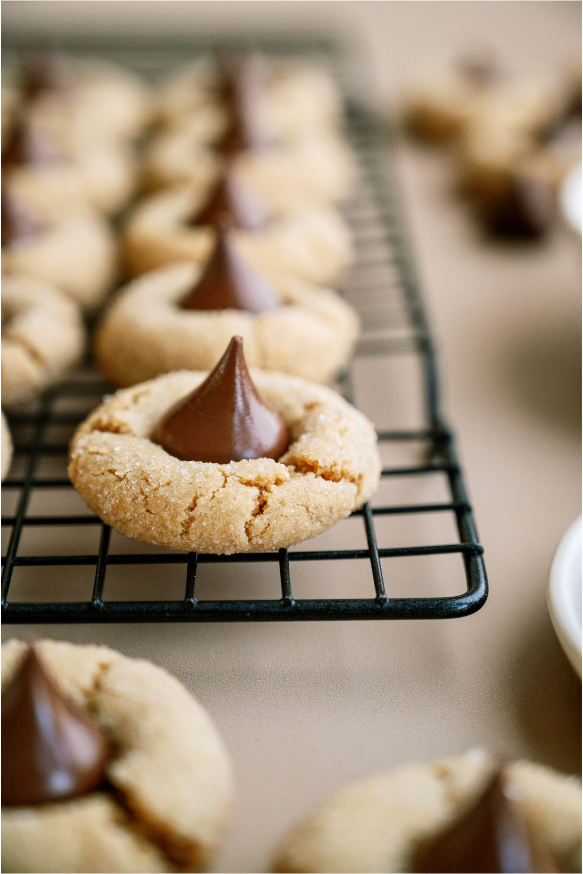 Close up of Peanut Butter Blossoms (Hershey’s Kiss Cookies) on a cooling rack.