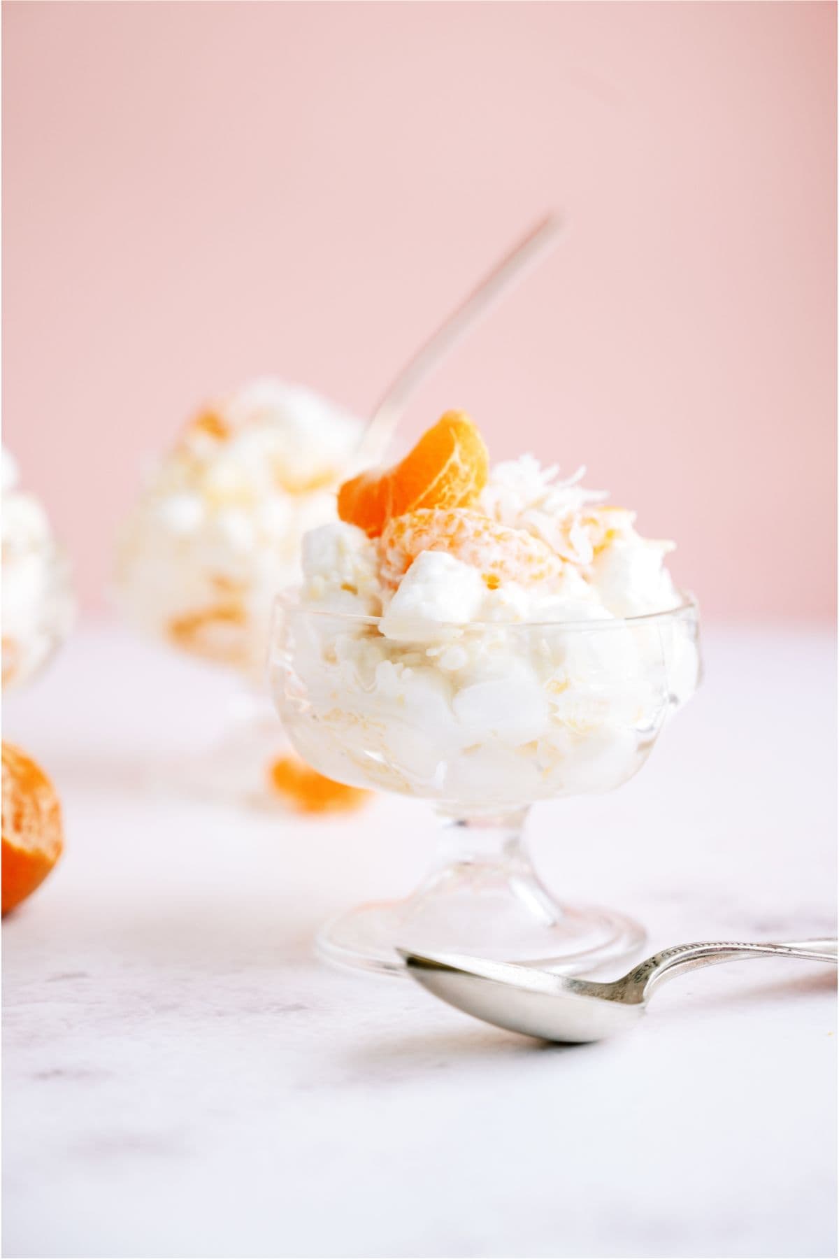 A small dish of 5 Cup Fruit Salad with a spoon