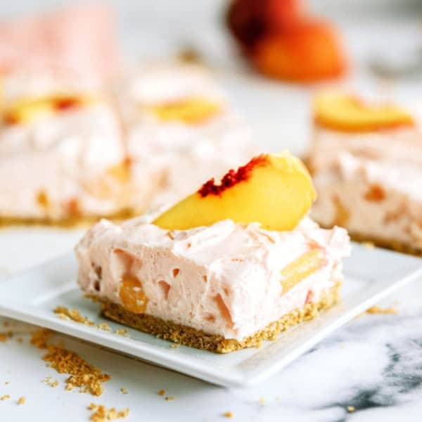 A square of No-Bake Peach Cheesecake Bars on a plate