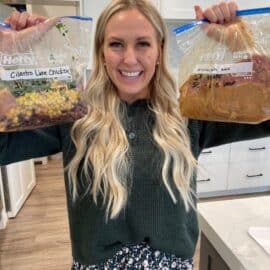 Kendra in a kitchen holds two freezer bags of meals labeled "Cilantro Lime Chicken" and "Honey Garlic Chicken."