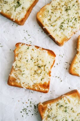 Top view of Several pieces of Cheesy Garlic Texas Toast on a countertop.