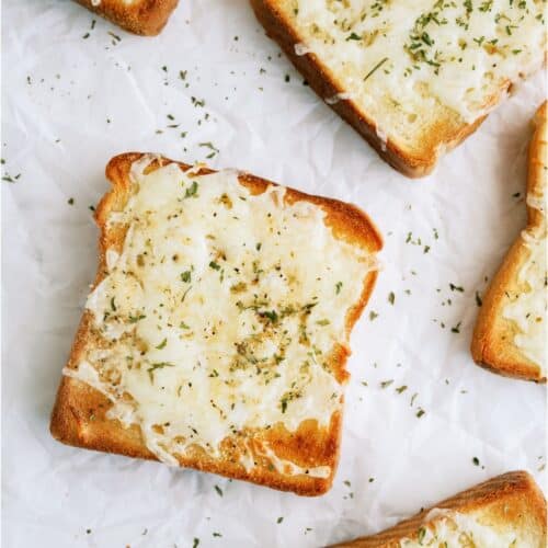 Top view of Several pieces of Cheesy Garlic Texas Toast on a countertop.