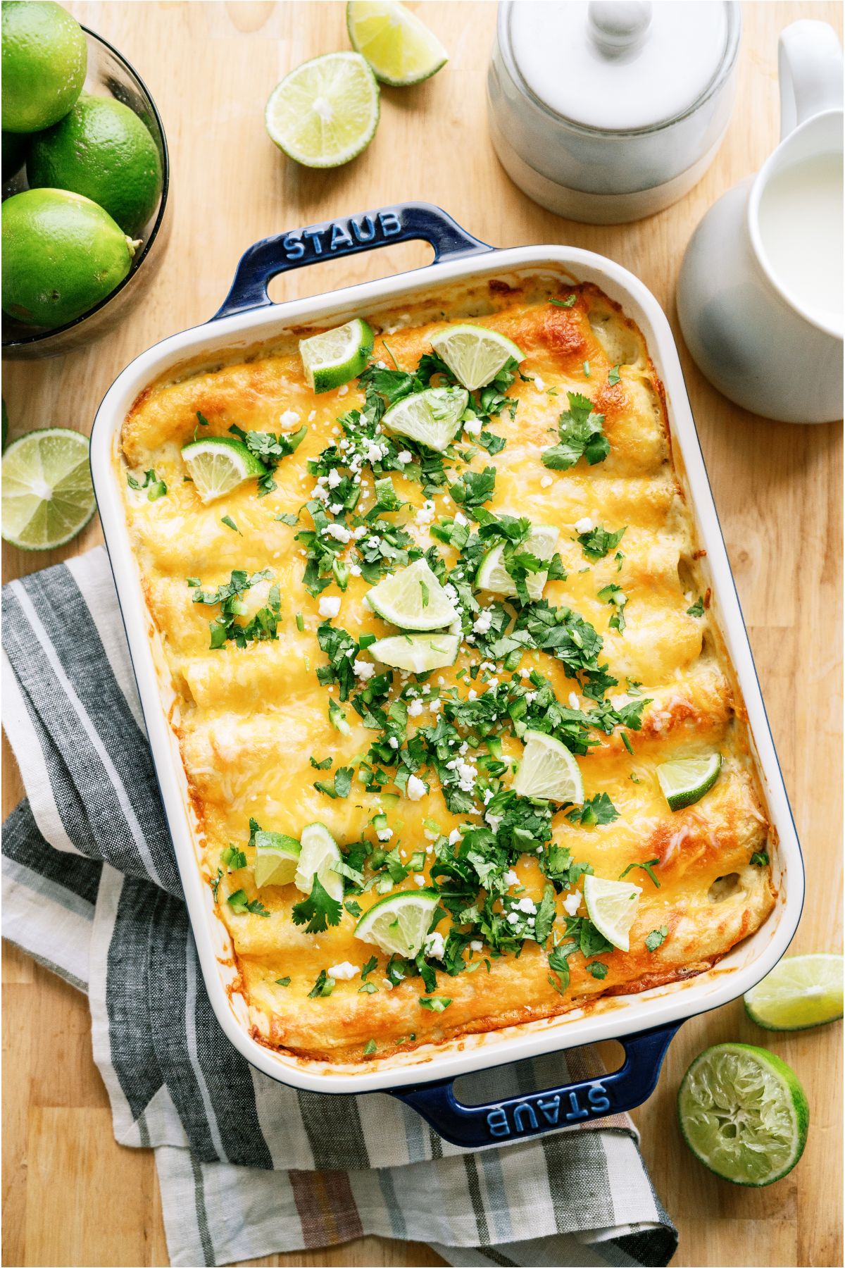 Top view of a large pan of Honey Lime Chicken Enchiladas topped with fresh cilantro and cheese.