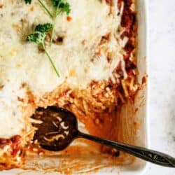 Baked Spaghetti Casserole with a serving spoon