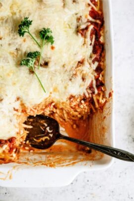 Baked Spaghetti Casserole with a serving spoon