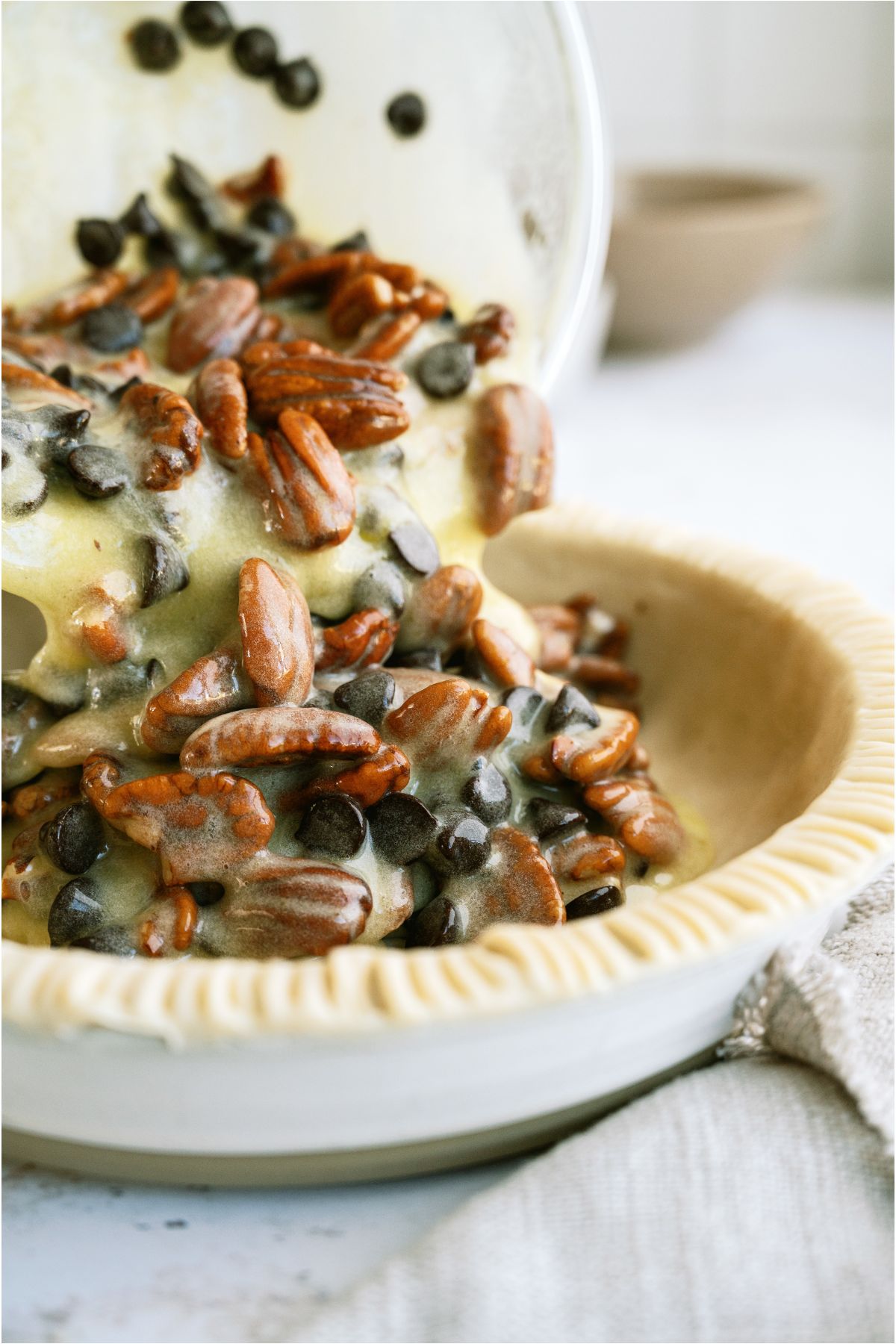 Egg mixture, pecan and chocolate chips mixed together and poured into a pie crust.