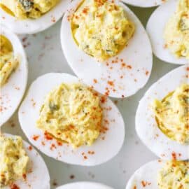 Close up of several Deviled Eggs on a white background.