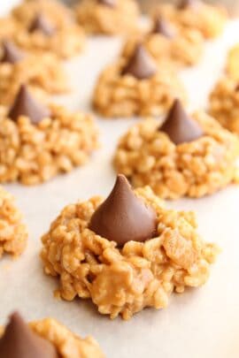 No Bake Peanut Butter Kiss Cookies lined up on parchment paper.