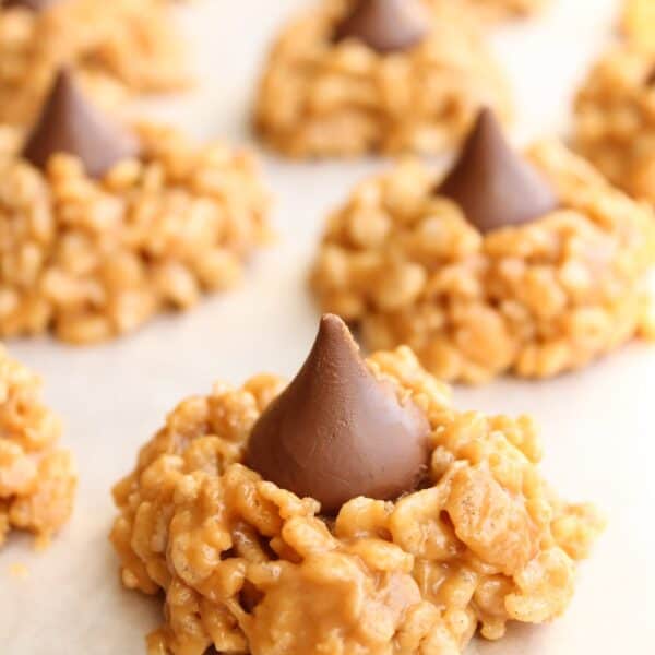 No Bake Peanut Butter Kiss Cookies lined up on parchment paper.