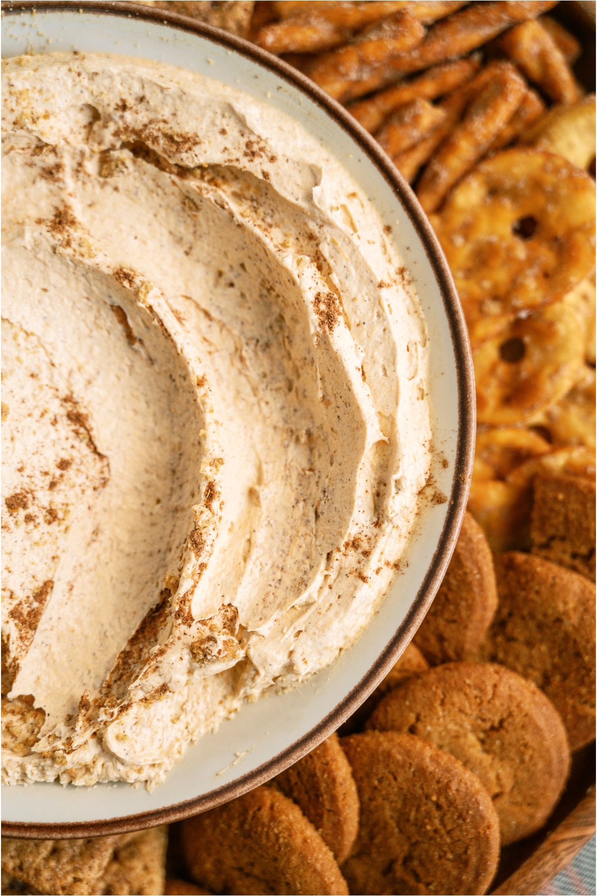 Close up of Pumpkin Dip in a bowl with cookies and crackers on the side.