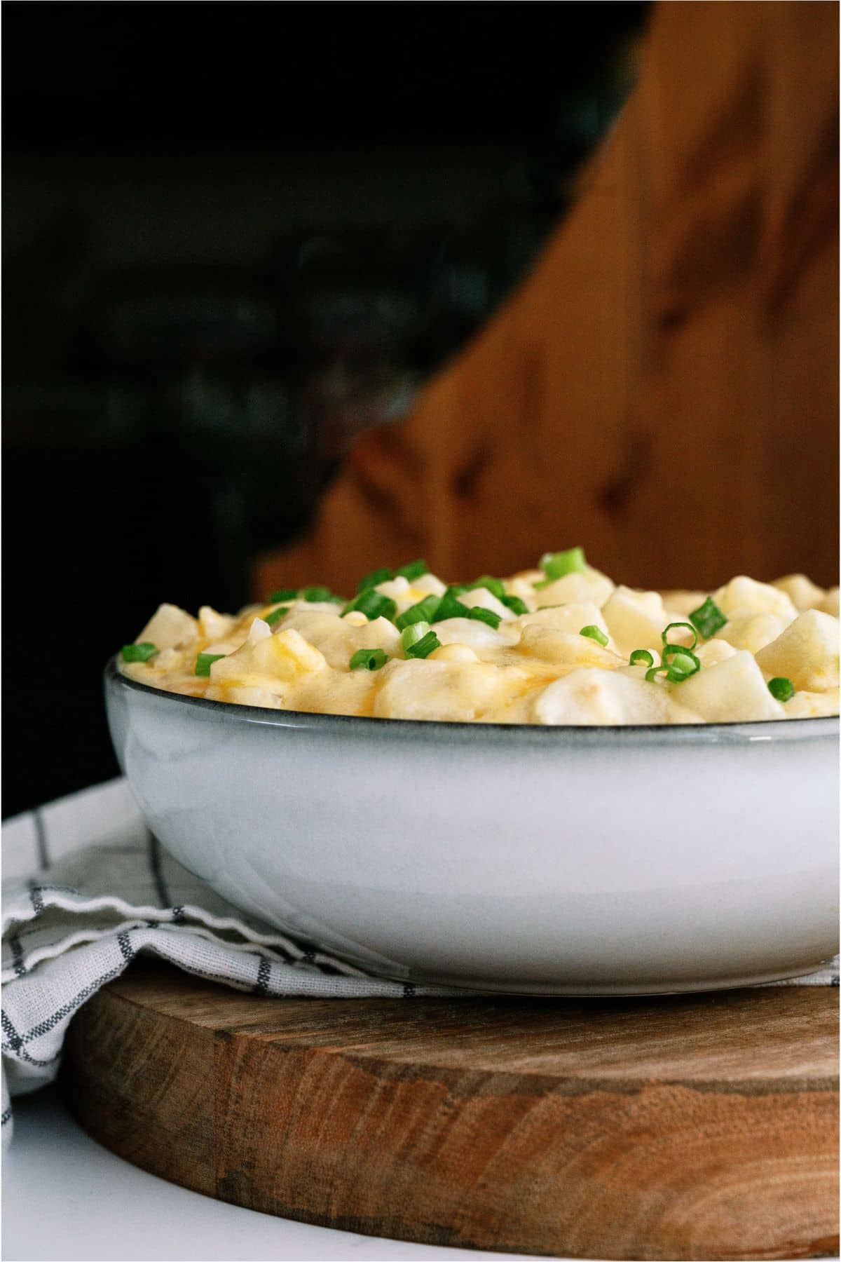 Side view of a bowl of Slow Cooker Cheesy Potatoes