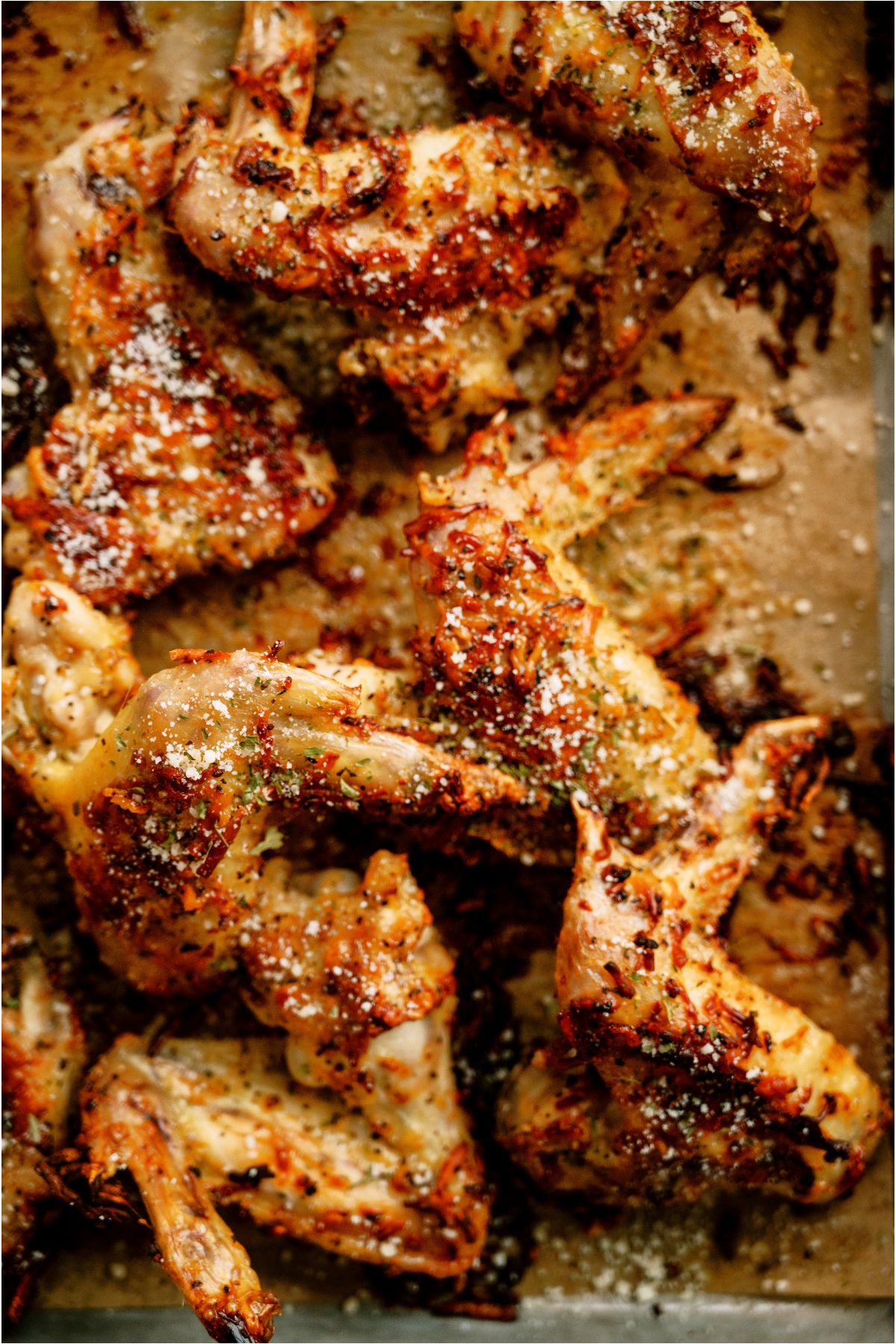 Close up view of Air Fryer Garlic Parmesan Chicken Wings on a sheet pan.