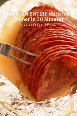 Slices of cooked ham arranged in a foil-lined dish with juice