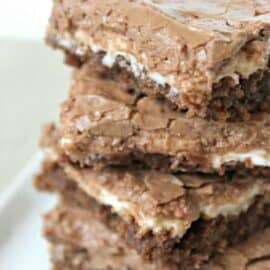 Mom's Famous Chocolate Marshmallow Brownies cut into squares and stacked on a plate