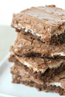 Mom's Famous Chocolate Marshmallow Brownies cut into squares and stacked on a plate