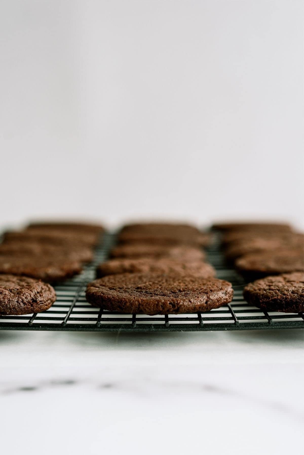 Chocolate cookies on a cooling rack.