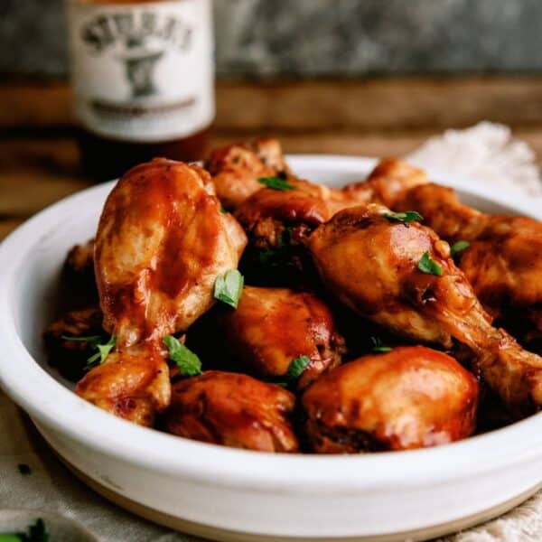slow cooker bbq chicken drumsticks on a white plate