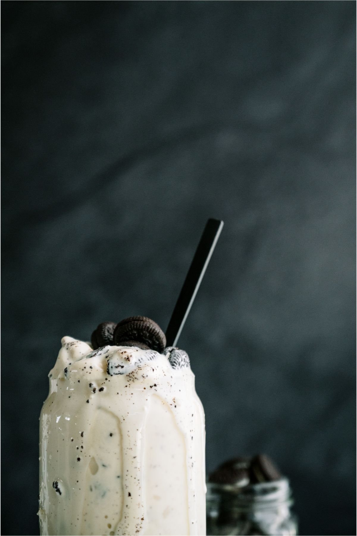 Top half of a Copycat Dairy Queen Blizzard in a glass with a straw