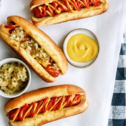 Air Fryer Hot Dogs on a table with toppings