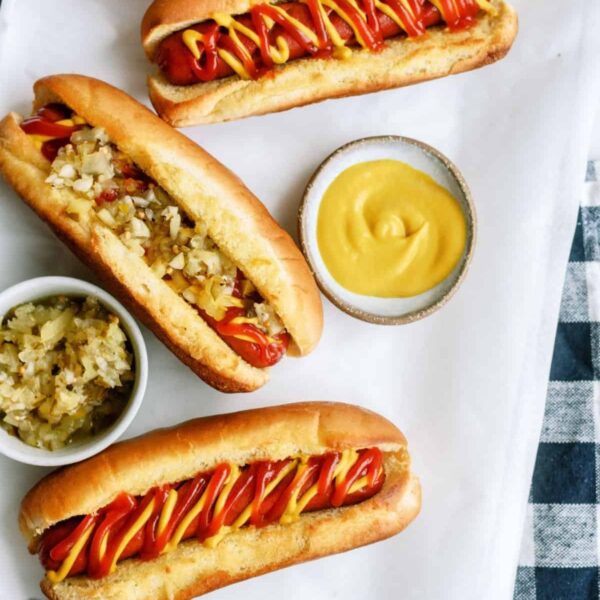 Air Fryer Hot Dogs on a table with toppings