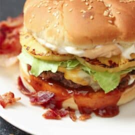 Bacon Infused Burger on a plate with toppings