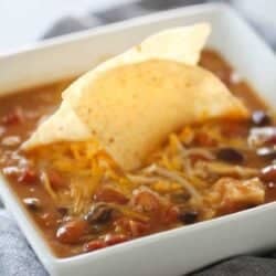 Slow Cooker 8-Can Taco Soup in a bowl with tortilla chips in the center