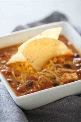 Slow Cooker 8-Can Taco Soup in a bowl with tortilla chips in the center