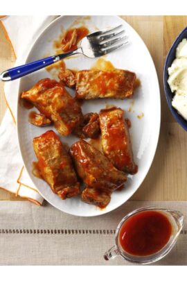 A plate of Slow Cooker BBQ Spareribs with a fork