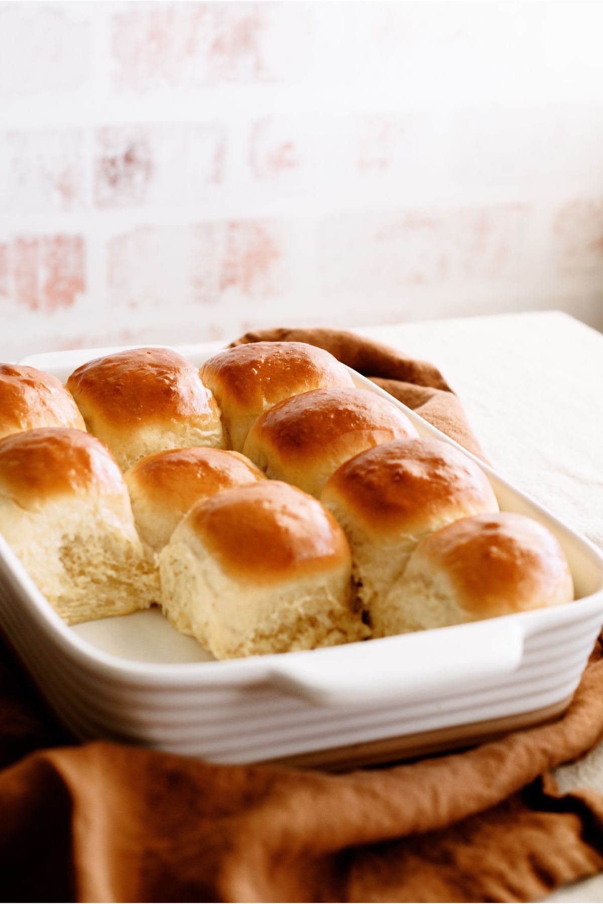 30 Minute Homemade Rolls in baking dish topped with butter.