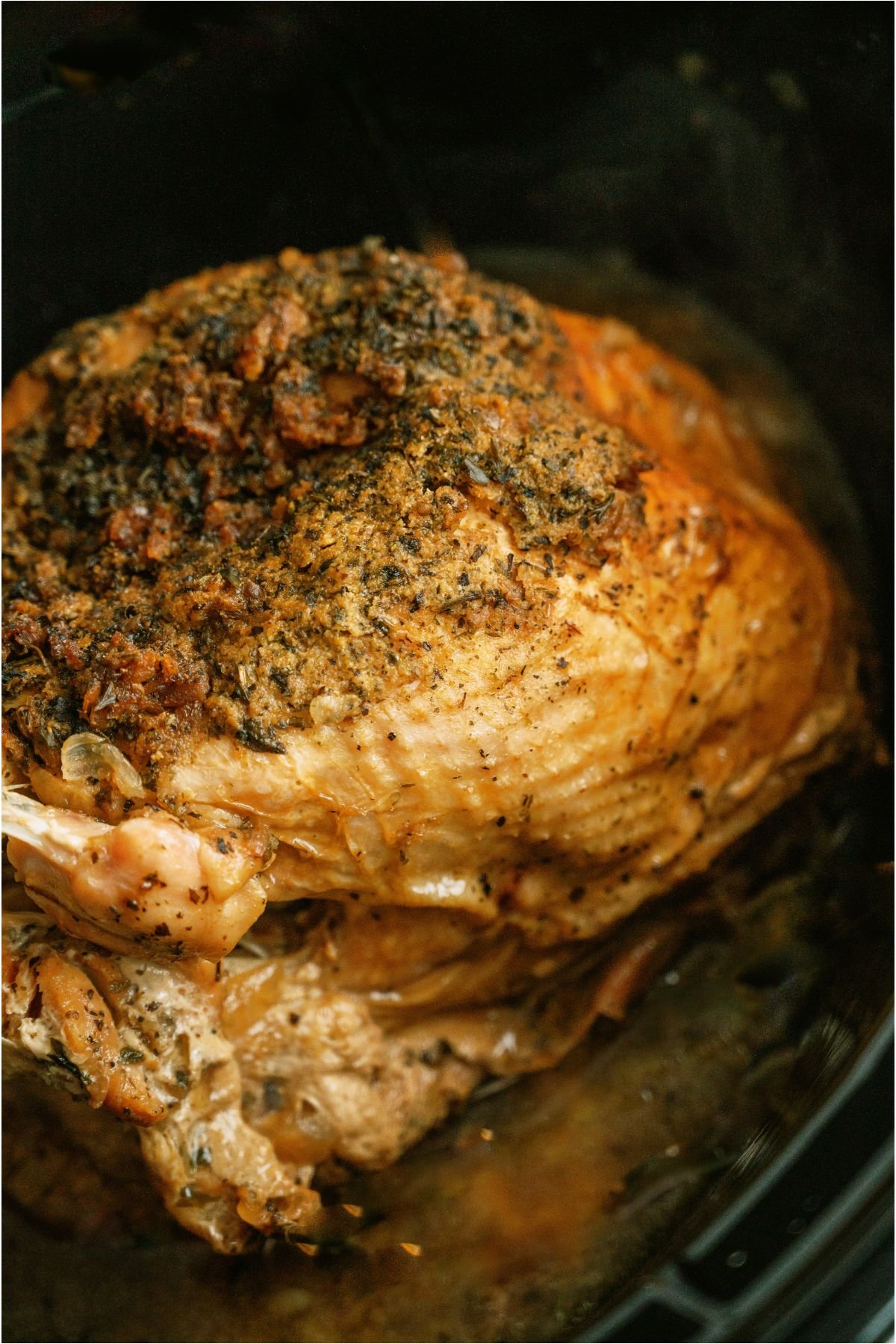 Seasoned and Cooked Crockpot Turkey Breast in Slow Cooker.