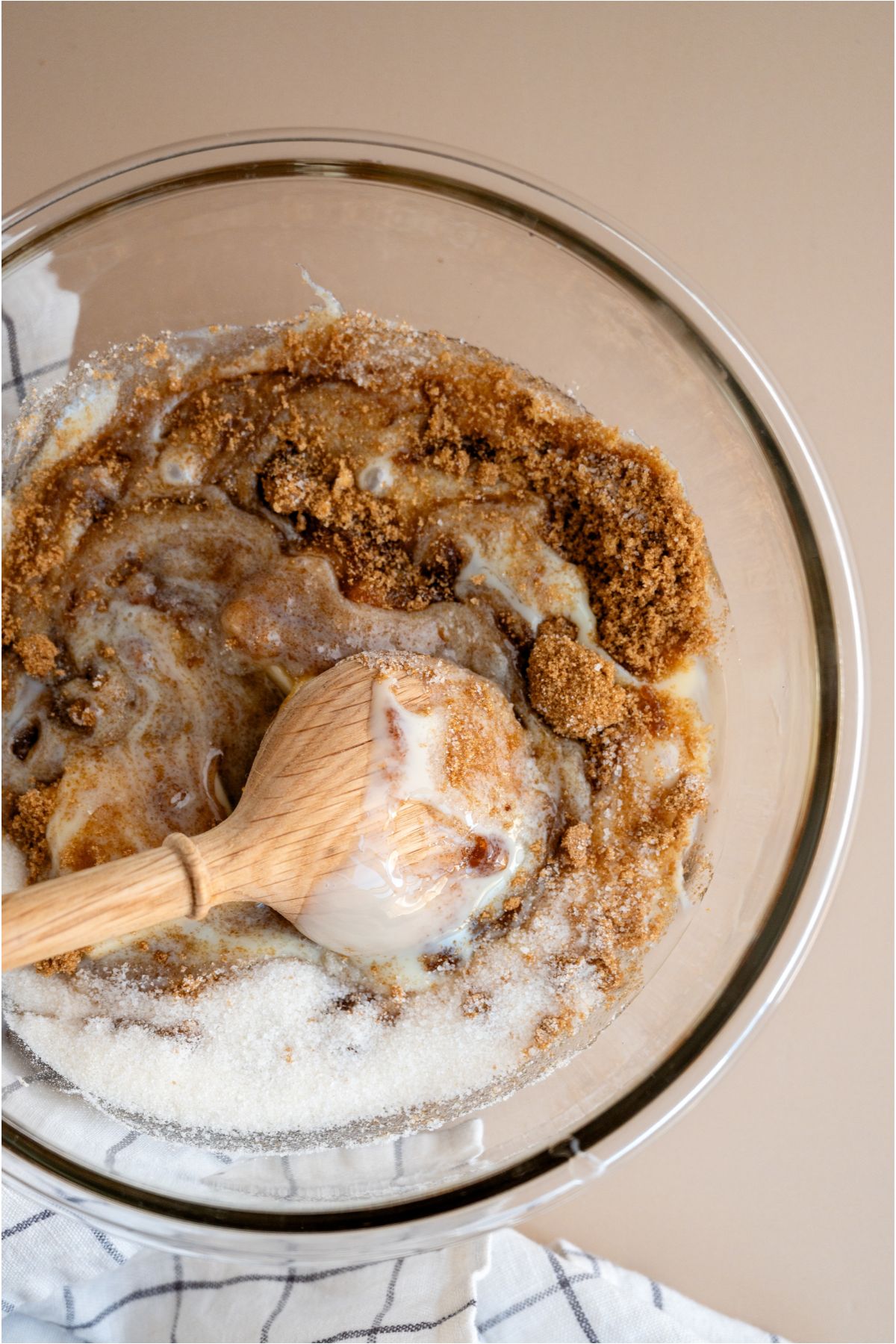 Stirring microwaved ingredients with a wooden spoon.