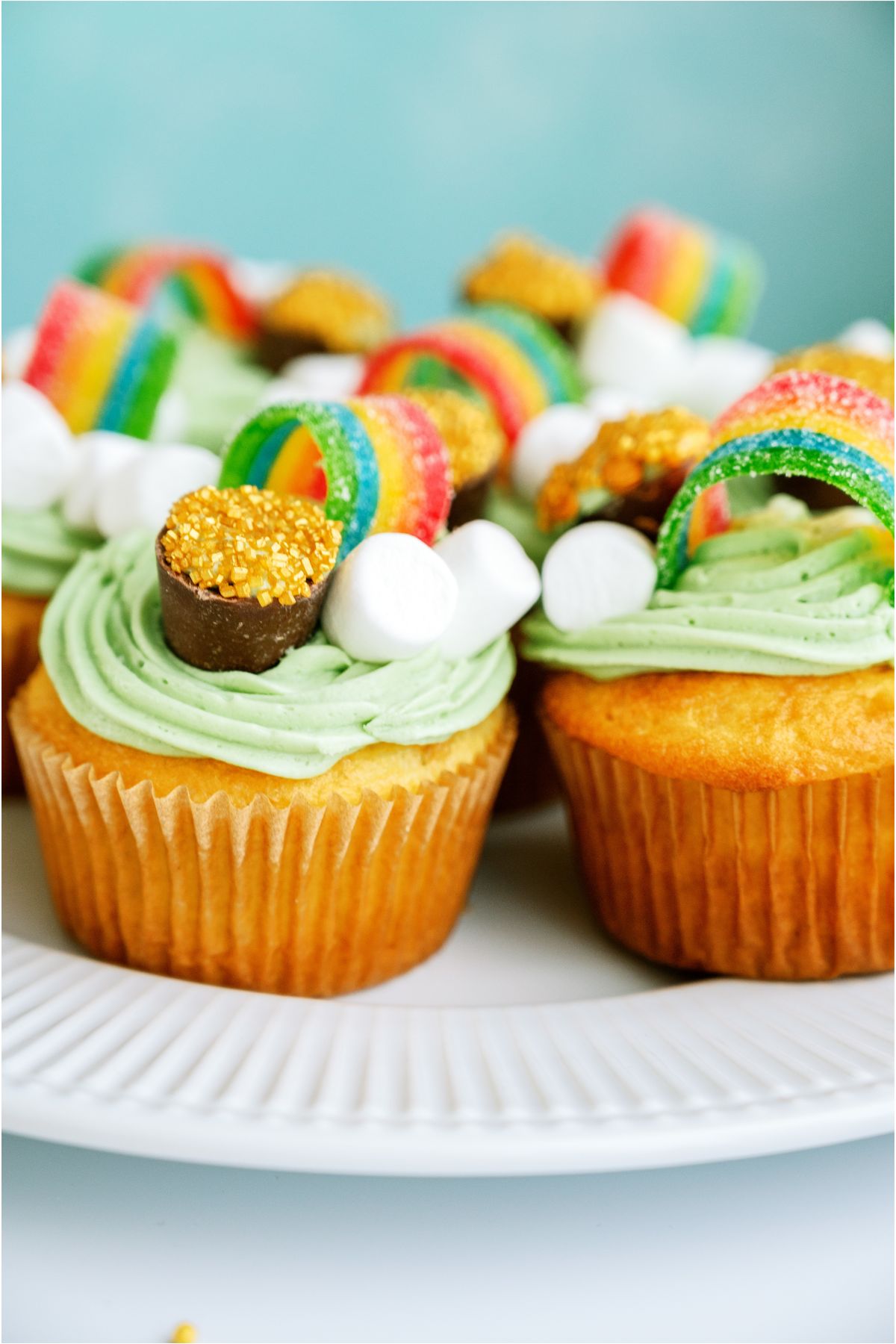 A serving plate with St. Patrick's Day Cupcakes bunched together on it.