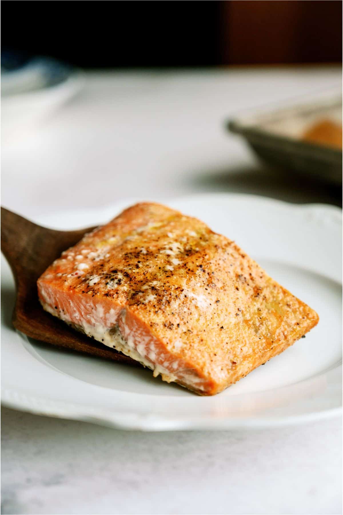 Baked Salmon filet being placed on a plate