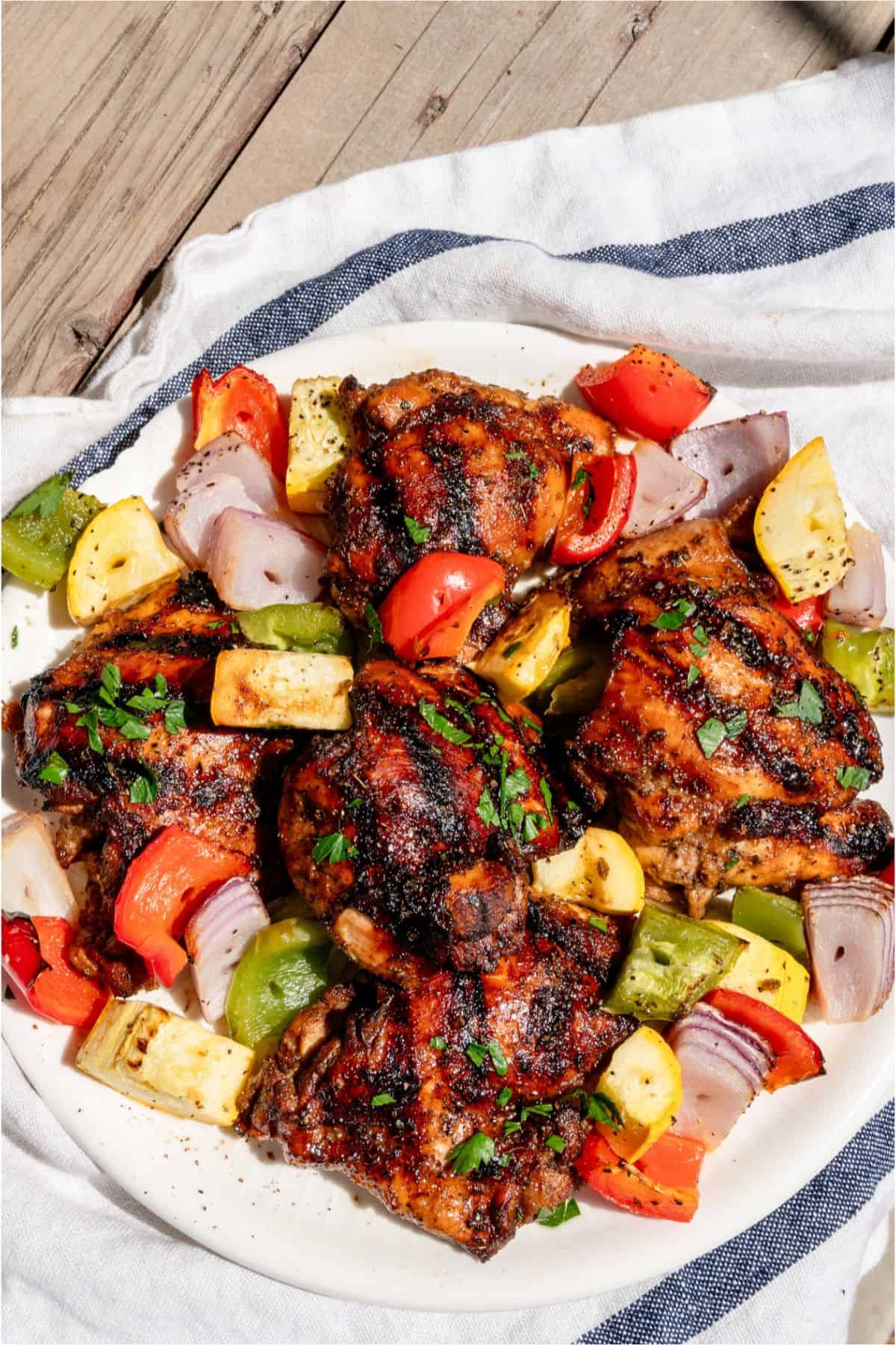 A plate of Grilled Boneless Chicken Thighs and Grilled veggies