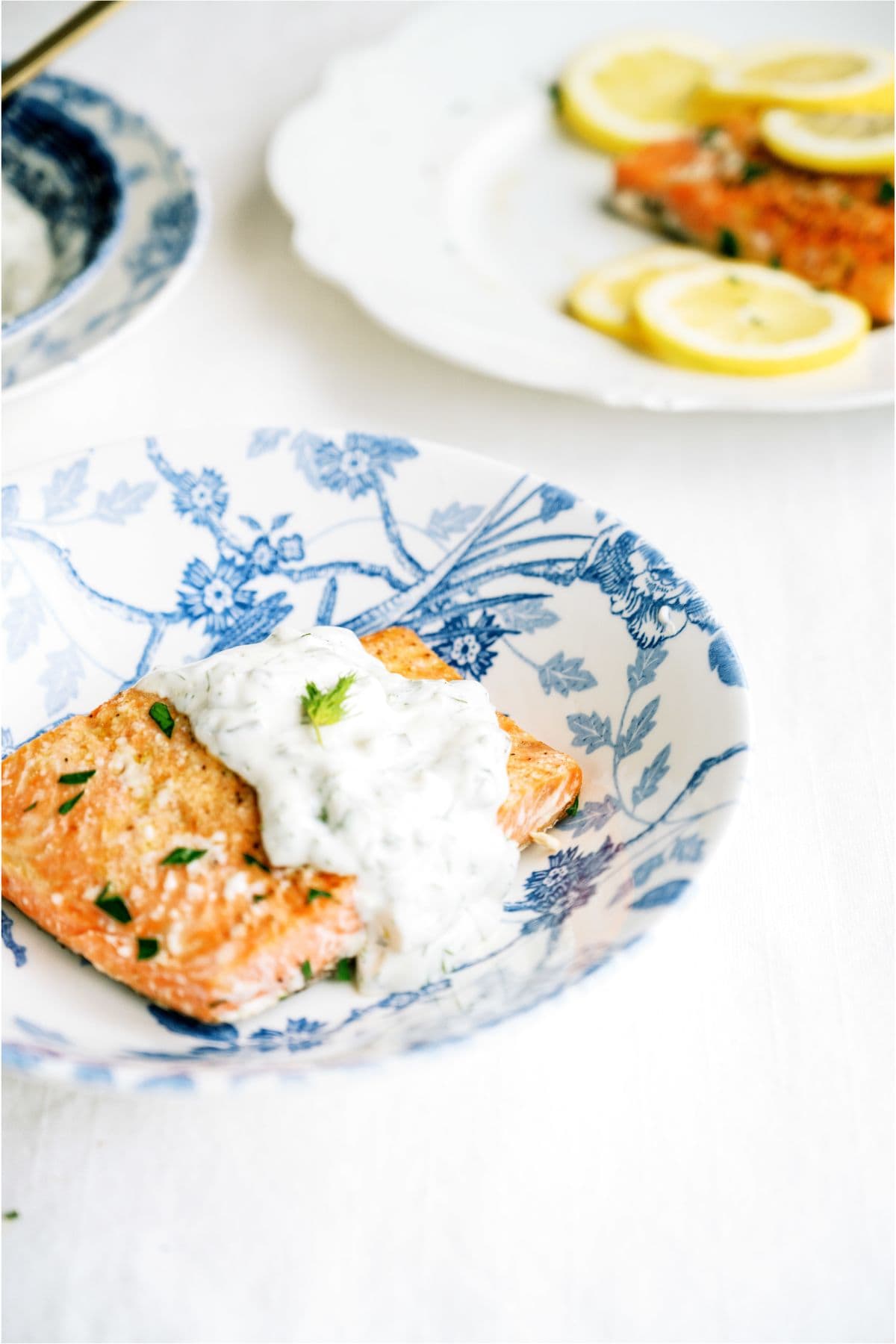 Salmon on a plate topped with Tartar Sauce