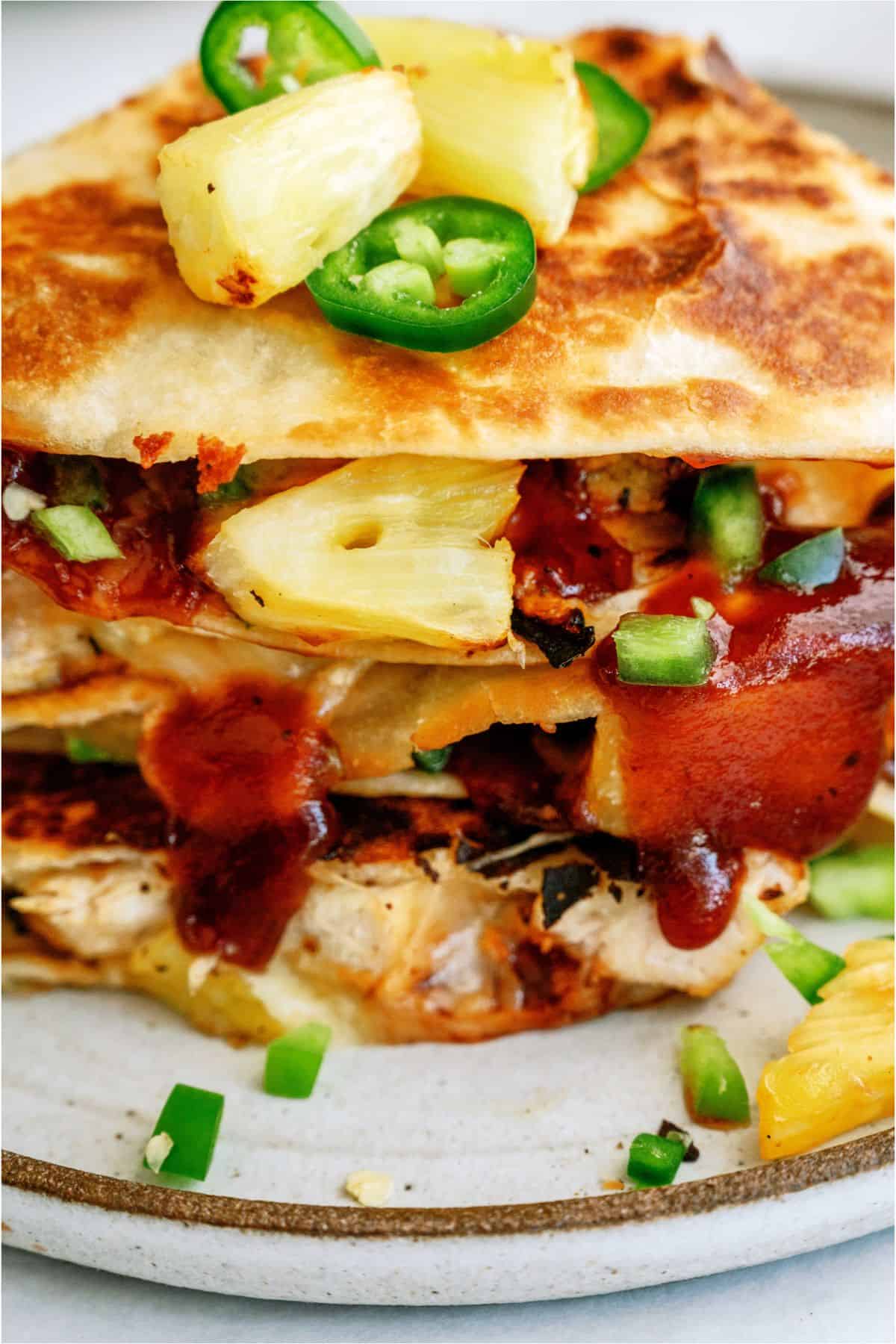 Close up view of sliced BBQ Chicken and Pineapple Quesadillas on a plate