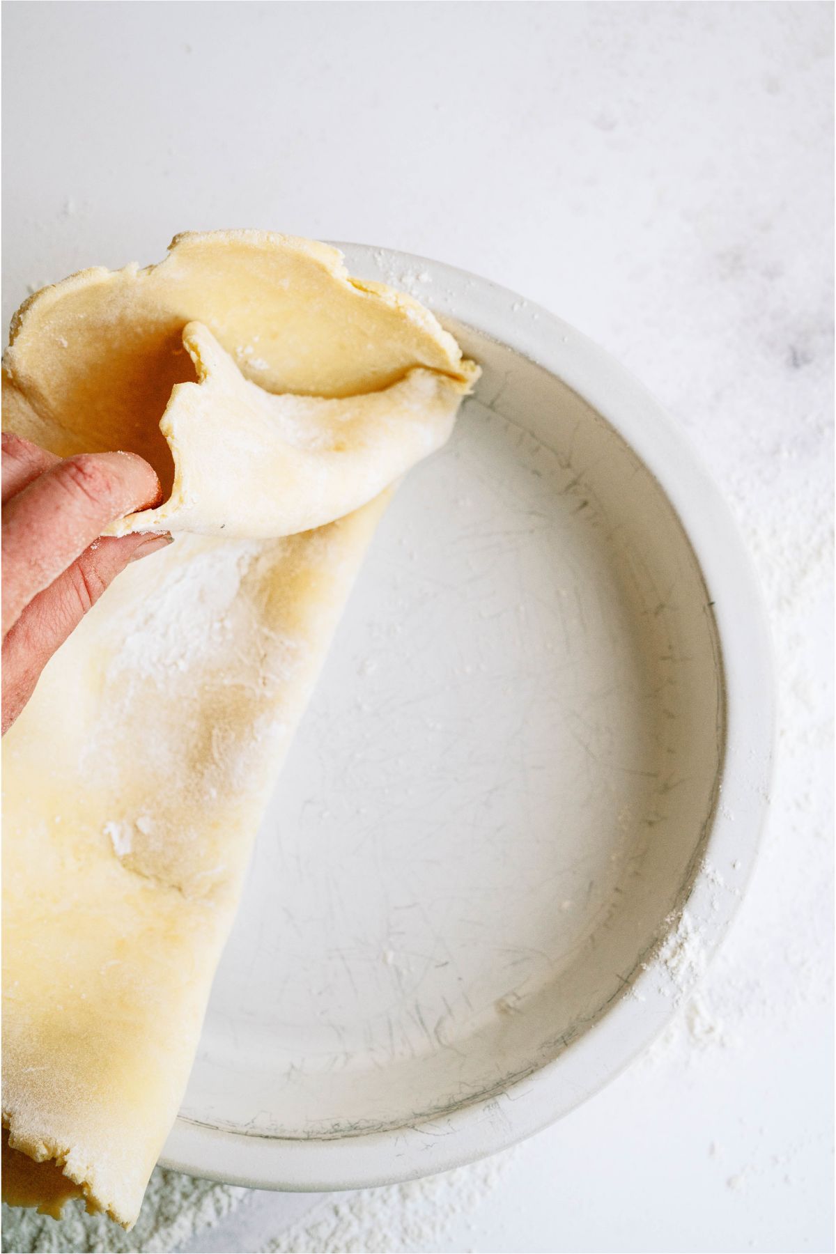Placing bottom pie crust into pan