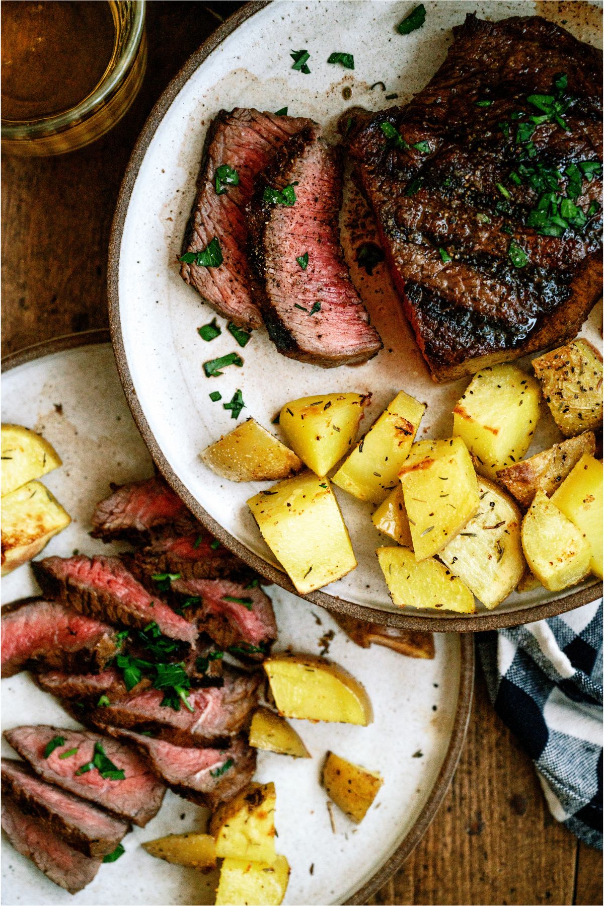 2 plates with sliced steak and potatoes
