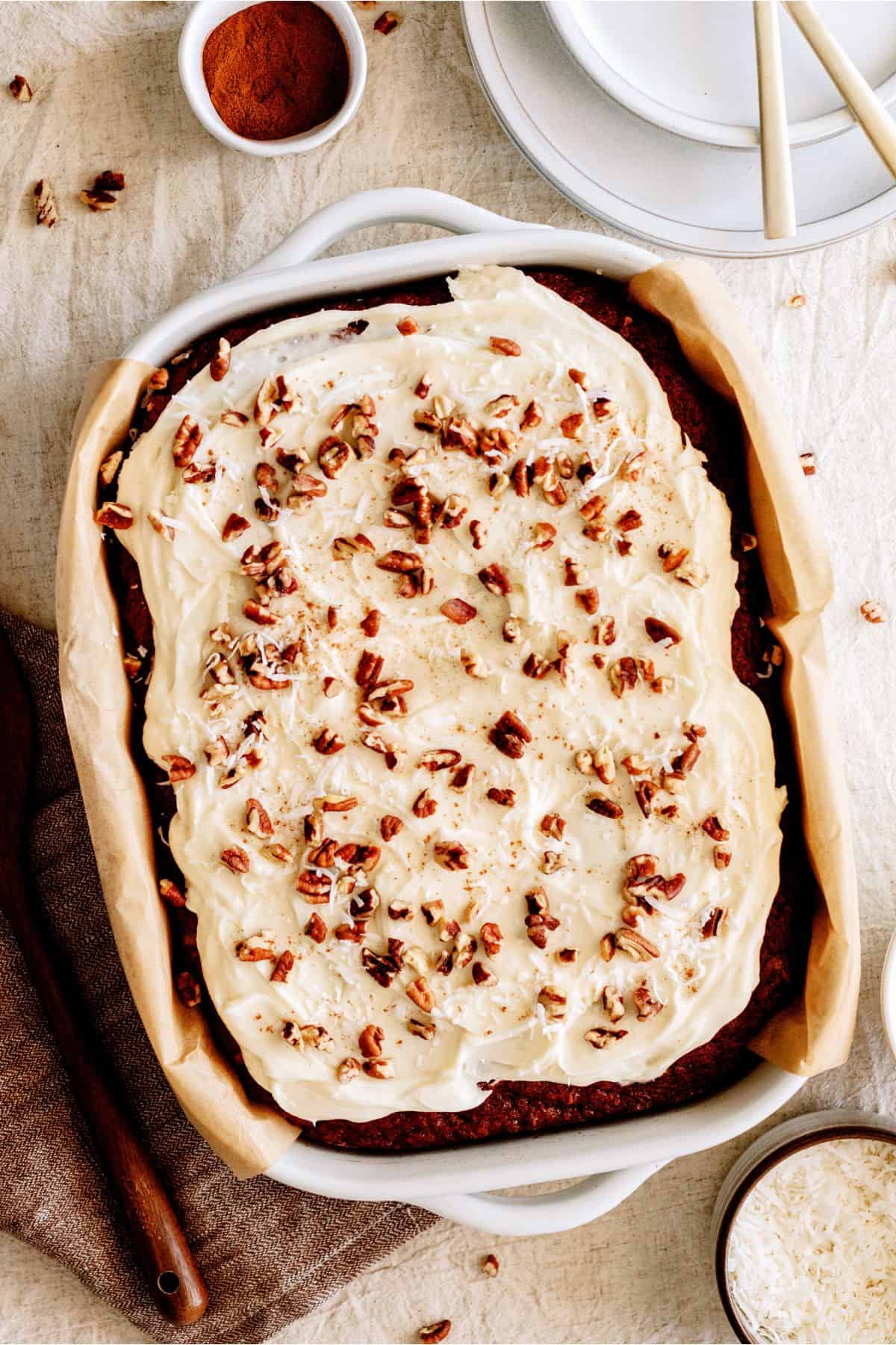 Preacher Cake with frosting topped with coconut flakes and pecans