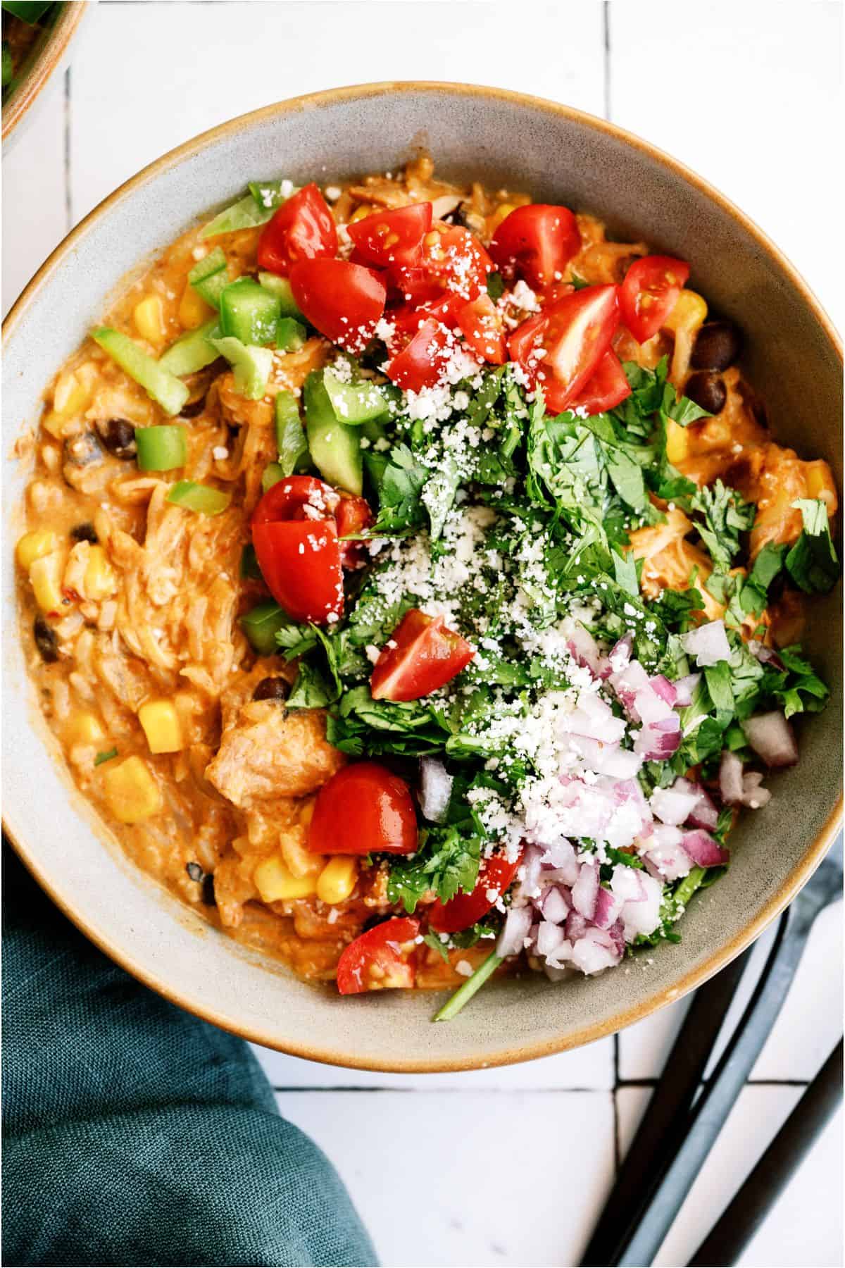 A bowl of Slow Cooker Southwest Chicken and Rice with toppings