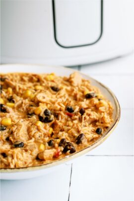 A bowl of Slow Cooker Southwest Chicken and Rice in front of a slow cooker
