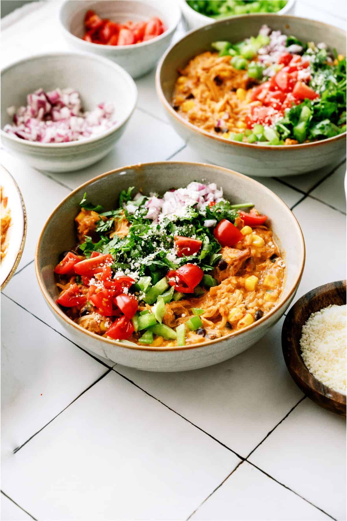 Bowls of Slow Cooker Southwest Chicken and Rice with toppings