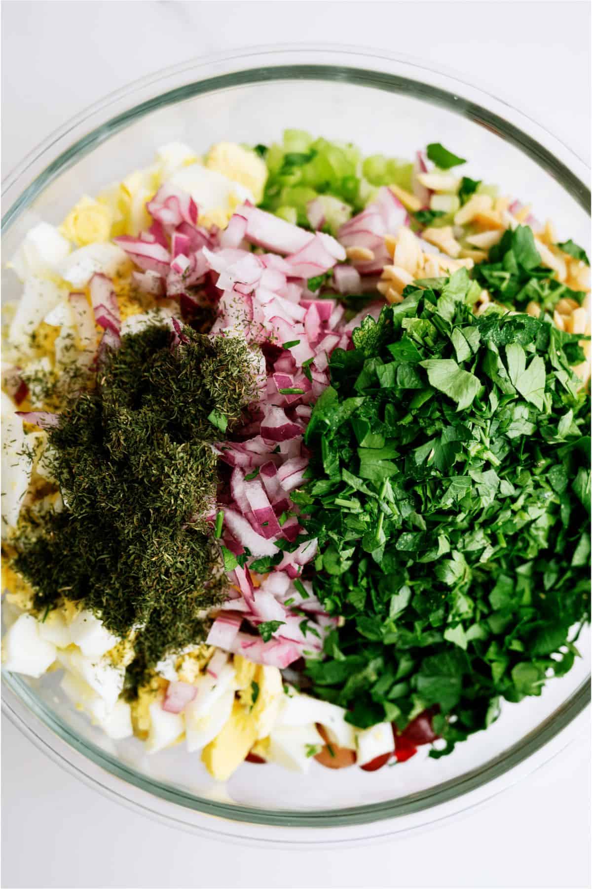 Ingredients for Chicken Salad with Eggs added to mixing bowl before they are mixed together