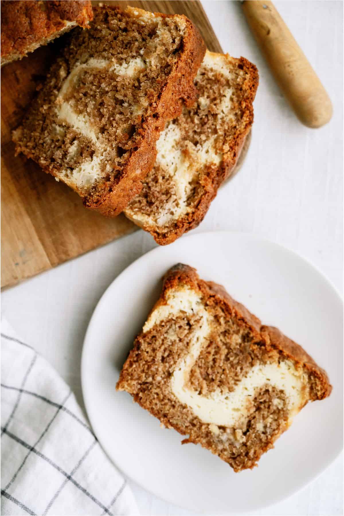 Slices of Cream Cheese Banana Bread on a cutting board and on a plate