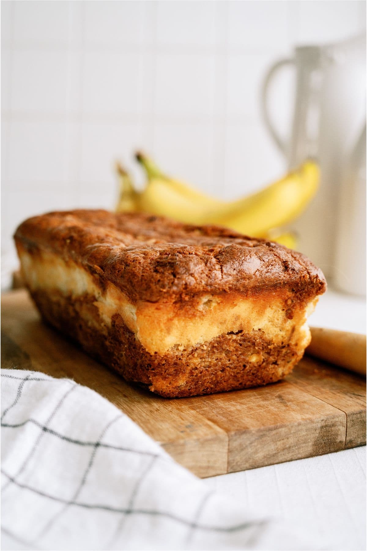 A loaf of Cream Cheese Banana Bread on a cutting board