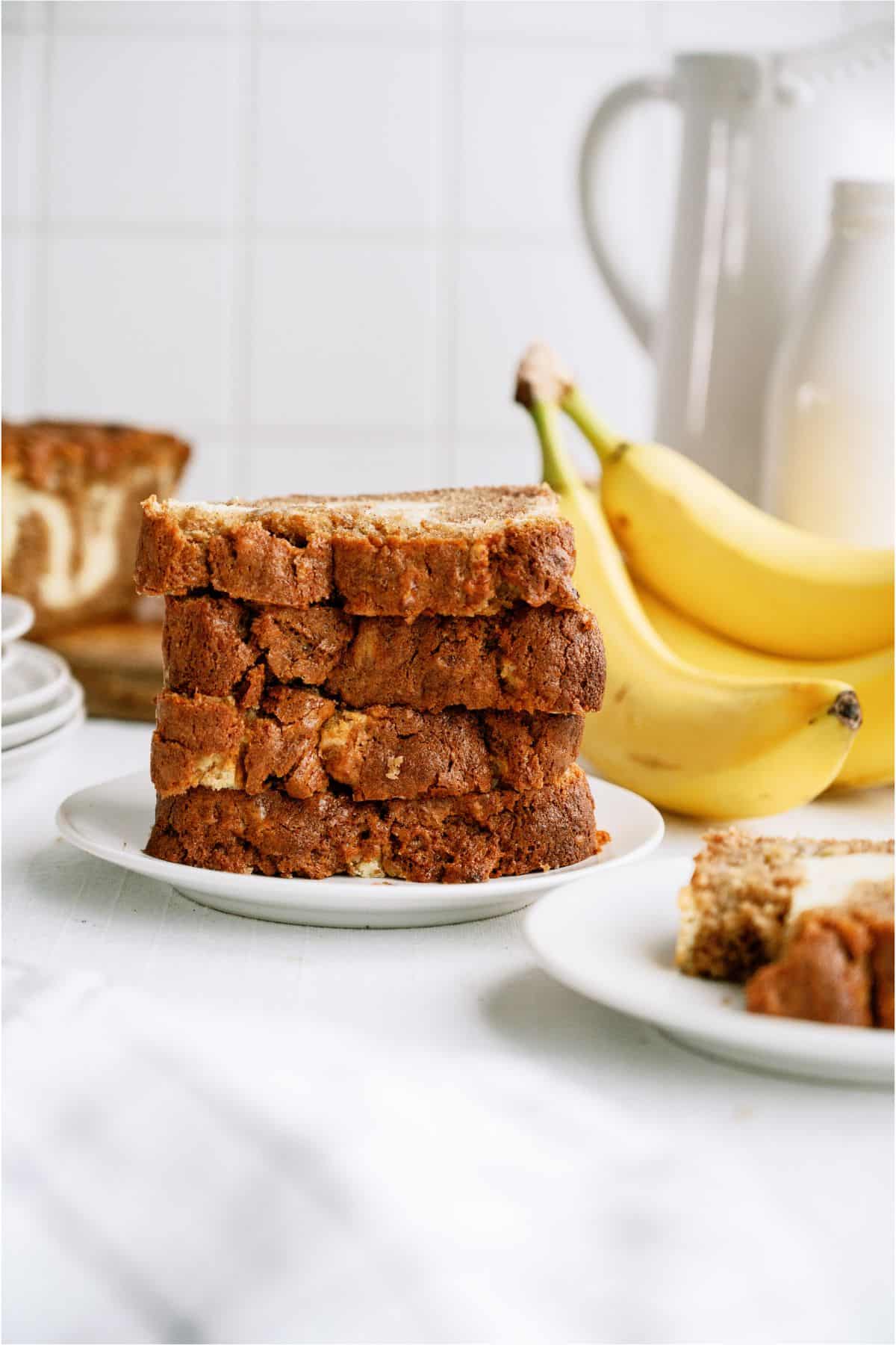 A plate with sliced Cream Cheese Banana Bread stacked